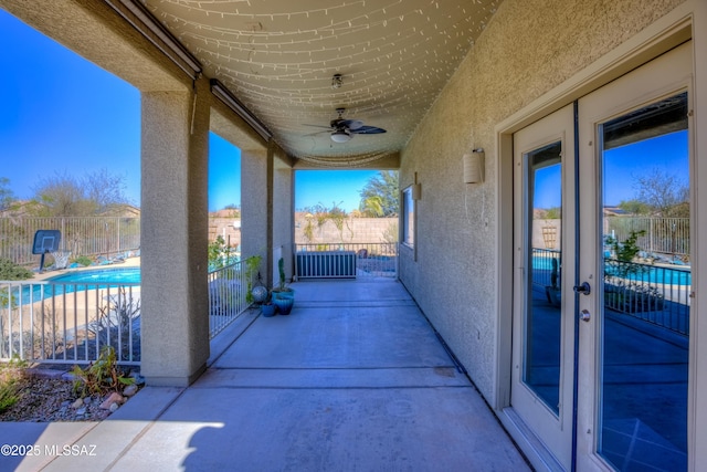 view of patio / terrace with a fenced in pool, ceiling fan, and fence