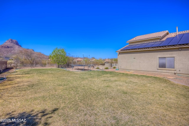 view of yard with a trampoline and a fenced backyard