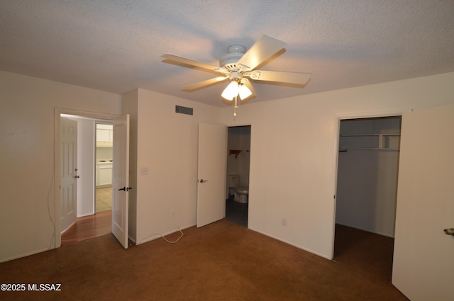 unfurnished bedroom with a closet, visible vents, a textured ceiling, and carpet flooring