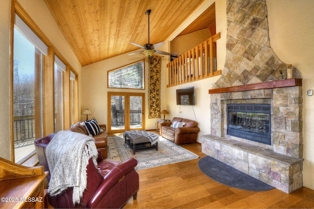11085 E Grosbeak Ln, Mount Lemmon, AZ 85619 - living area with wooden ceiling, wood finished floors, ceiling fan, a stone fireplace, and vaulted ceiling
