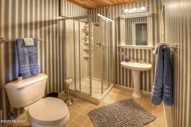 11085 E Grosbeak Ln, Mount Lemmon, AZ 85619 - bathroom with wallpapered walls, a stall shower, toilet, baseboards, and tile patterned flooring