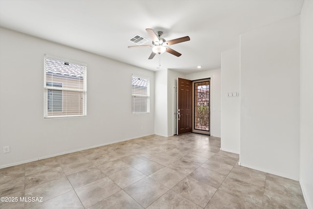 foyer with visible vents, baseboards, and a ceiling fan