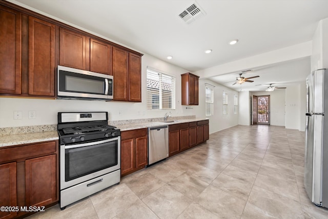 kitchen with light stone counters, visible vents, recessed lighting, a sink, and stainless steel appliances