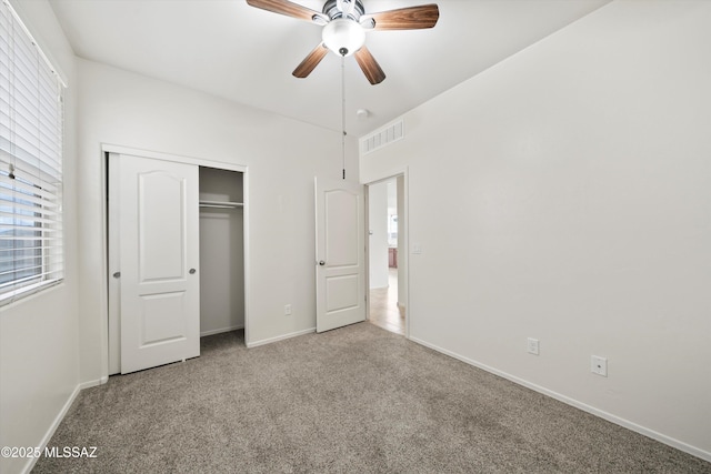 unfurnished bedroom featuring visible vents, carpet, a closet, and baseboards