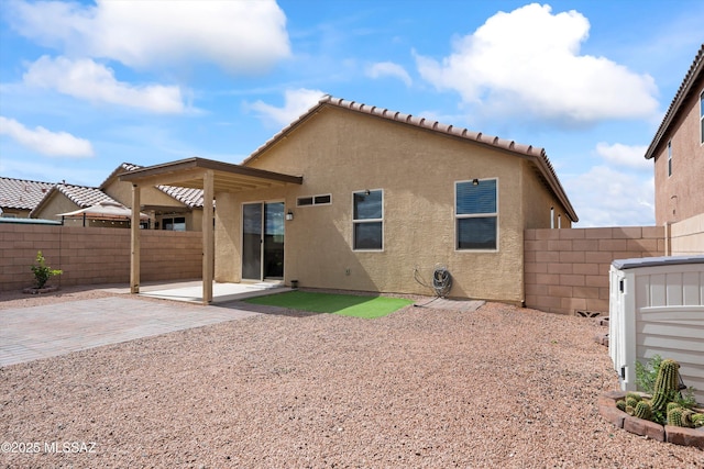 back of property featuring a patio area, stucco siding, and a fenced backyard