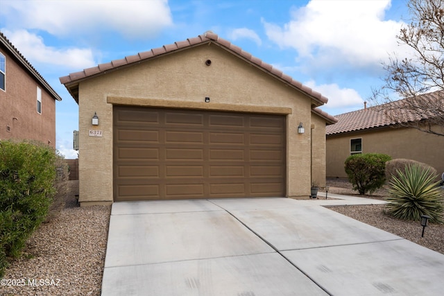 garage featuring concrete driveway