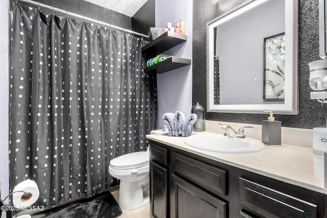 bathroom featuring a shower with curtain, toilet, vanity, and a textured wall