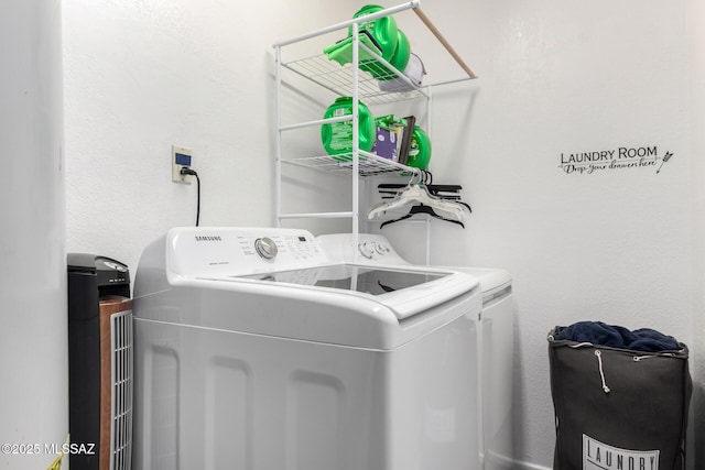 laundry area with laundry area and washing machine and clothes dryer