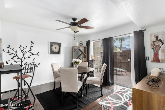 dining space with wood finished floors, baseboards, and ceiling fan