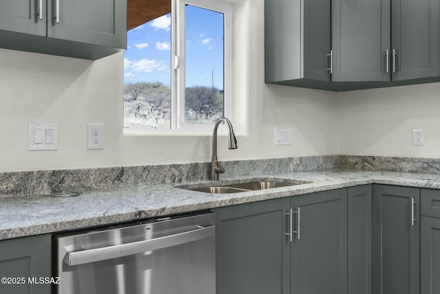 kitchen with a sink, stainless steel dishwasher, and gray cabinetry