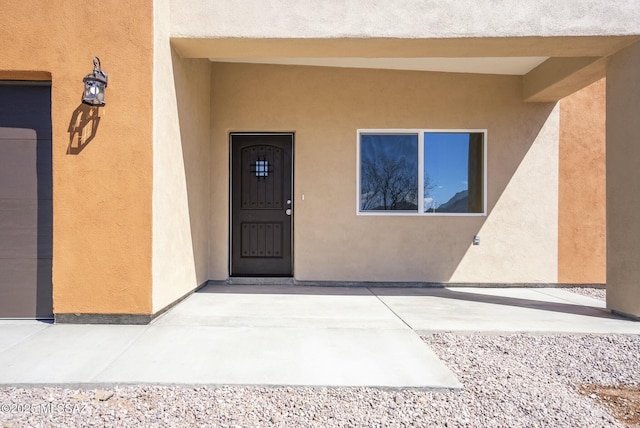 doorway to property with stucco siding