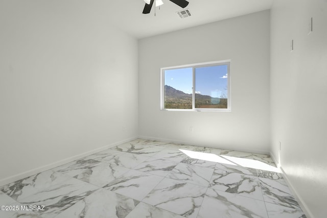 unfurnished room with marble finish floor, visible vents, ceiling fan, and baseboards