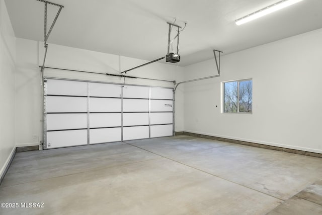 garage with baseboards and a garage door opener