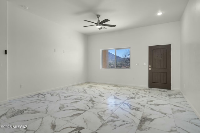 spare room featuring recessed lighting, marble finish floor, ceiling fan, and baseboards