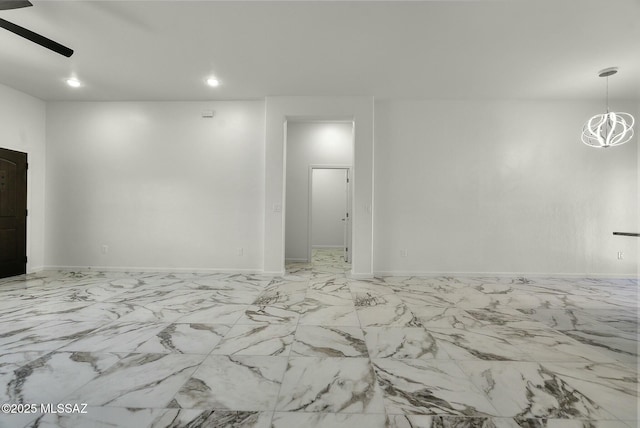 empty room with recessed lighting, baseboards, and ceiling fan with notable chandelier