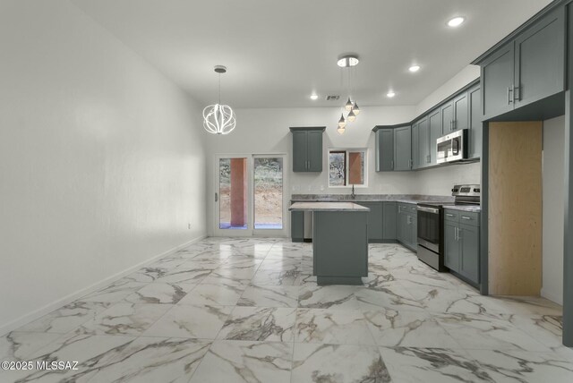 kitchen with baseboards, a center island, marble finish floor, stainless steel appliances, and light countertops