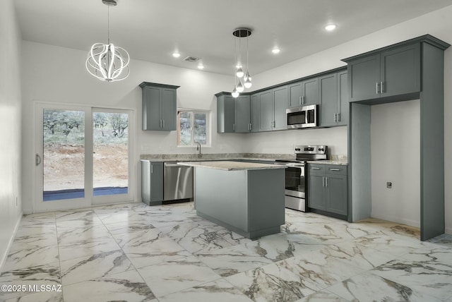 kitchen featuring recessed lighting, a kitchen island, a sink, visible vents, and appliances with stainless steel finishes