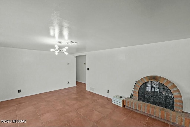 unfurnished living room with a notable chandelier, visible vents, tile patterned flooring, and a fireplace