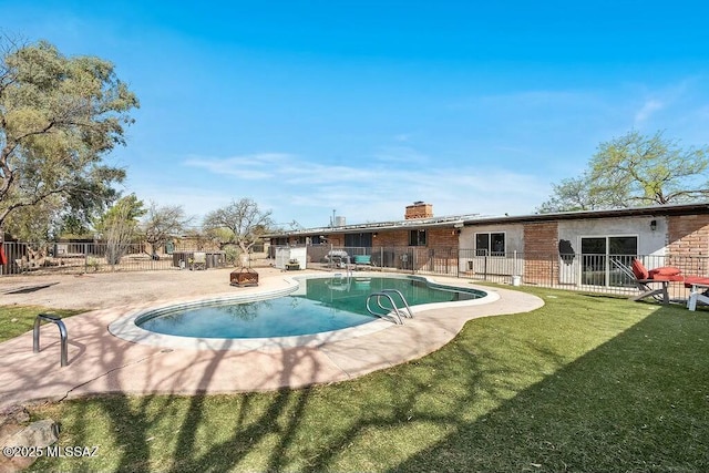view of pool featuring a patio area, a fenced in pool, fence, and a yard