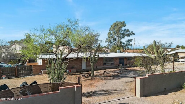 single story home featuring brick siding and fence
