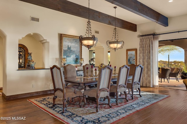 dining space with visible vents, beamed ceiling, baseboards, and wood finished floors