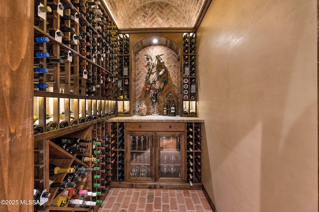 wine cellar featuring brick ceiling and brick floor