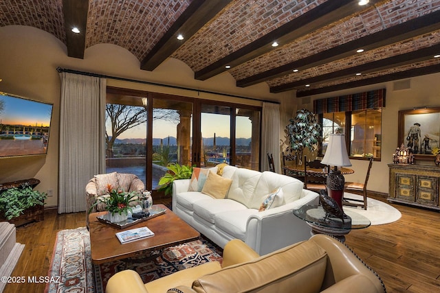 living area with brick ceiling, baseboards, and hardwood / wood-style flooring