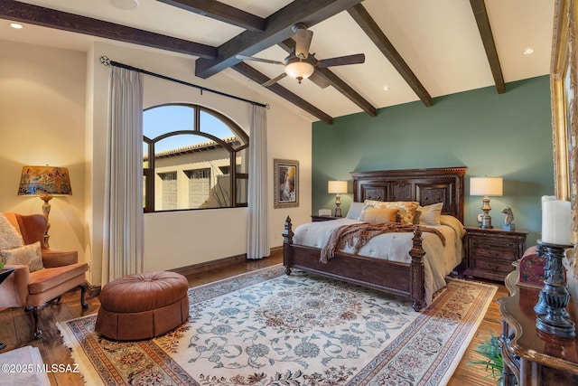 bedroom featuring lofted ceiling with beams, a ceiling fan, baseboards, and wood finished floors