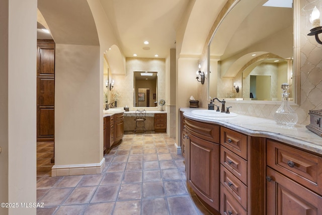 bathroom featuring recessed lighting, backsplash, vanity, and tile patterned floors