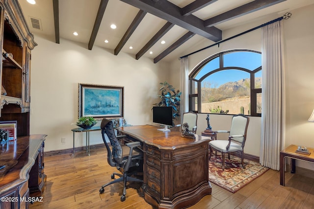 home office with lofted ceiling with beams, light wood-type flooring, visible vents, and baseboards