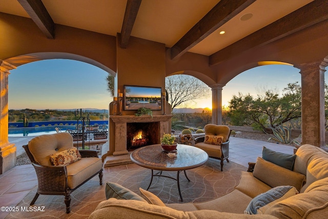 view of patio / terrace with an outdoor pool and an outdoor living space with a fireplace