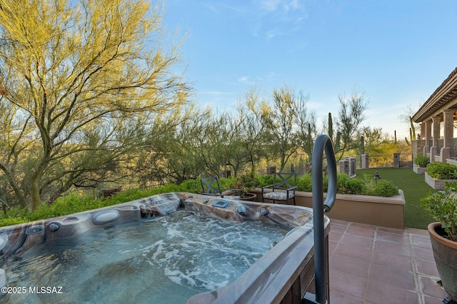 view of pool featuring a lawn and a hot tub