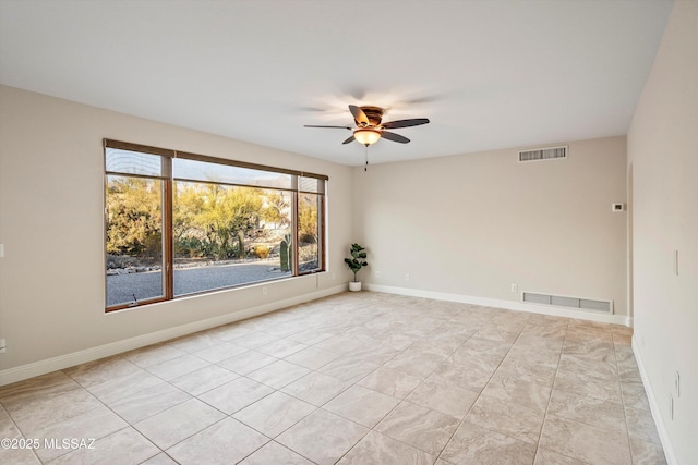 empty room with a ceiling fan, visible vents, and baseboards