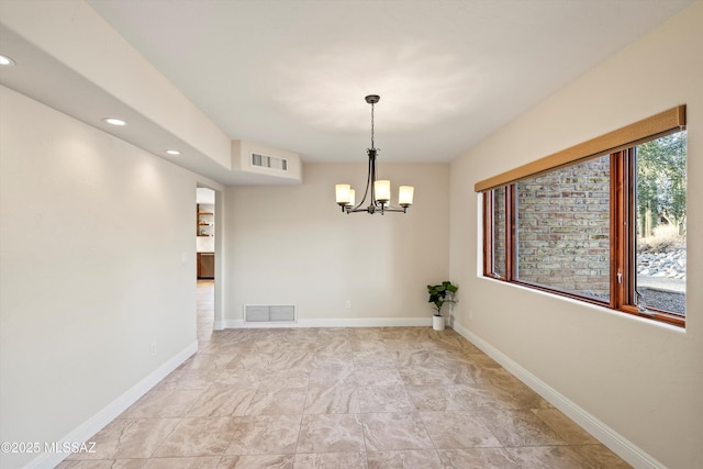 unfurnished room with an inviting chandelier, baseboards, and visible vents