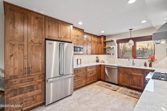 kitchen with a sink, light countertops, appliances with stainless steel finishes, backsplash, and open shelves