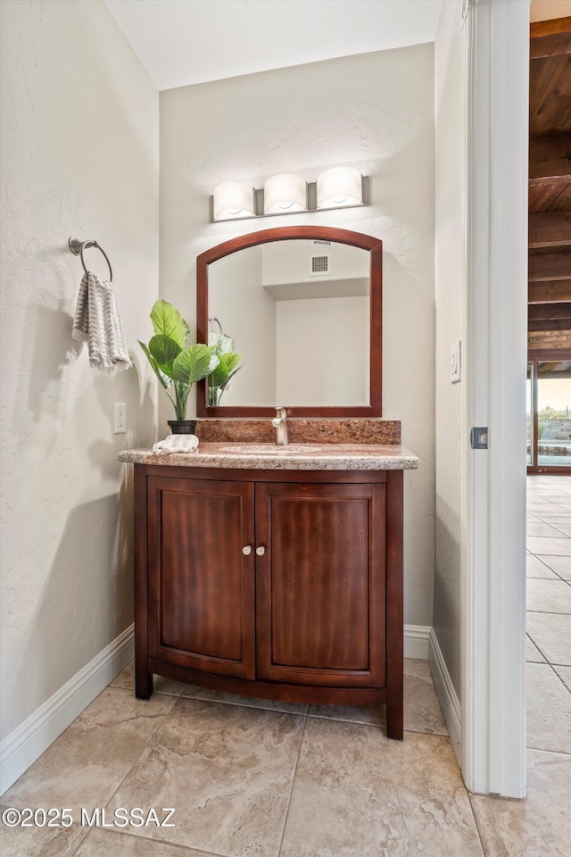 bathroom with visible vents, vanity, and baseboards