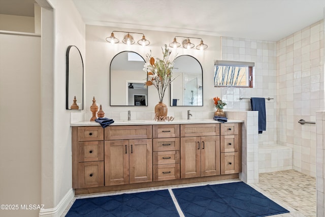 full bath with double vanity, walk in shower, and a sink