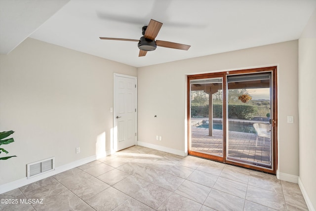 unfurnished room featuring a ceiling fan, visible vents, and baseboards