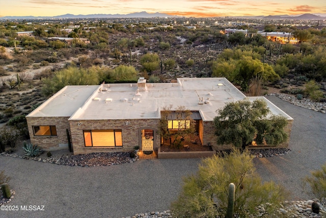 exterior space featuring gravel driveway and a mountain view