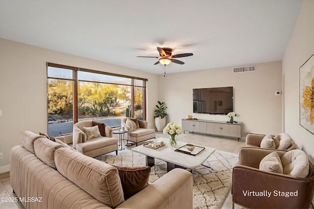 living room featuring baseboards, visible vents, and a ceiling fan