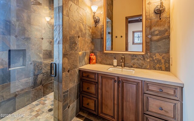 full bathroom with backsplash, a stall shower, tile walls, and vanity