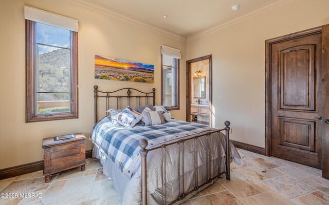 bedroom featuring ensuite bath, crown molding, baseboards, and stone tile flooring