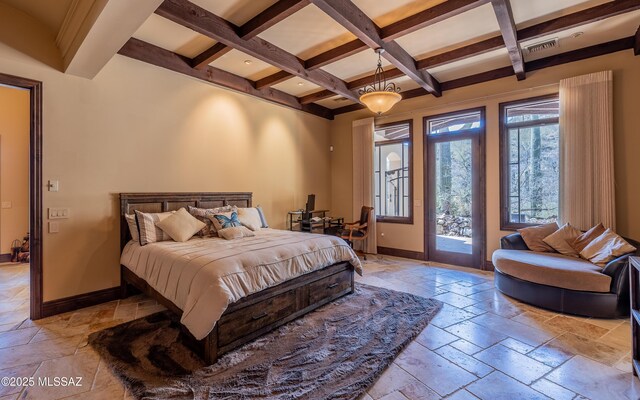 bedroom with access to exterior, stone tile floors, and baseboards