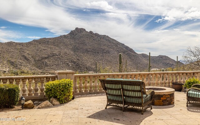 view of patio featuring a mountain view and an outdoor fire pit