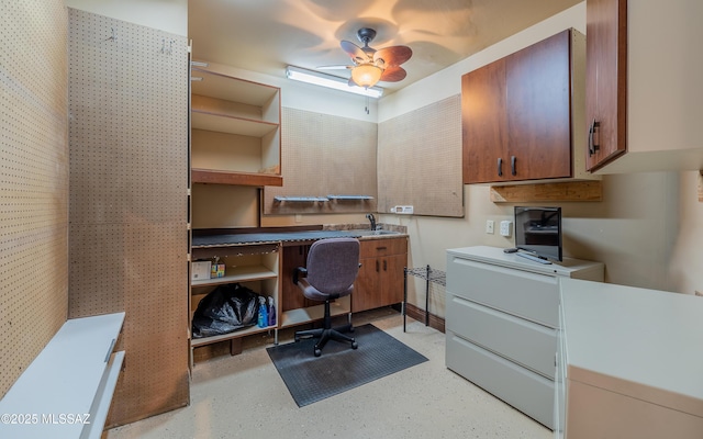 home office with ceiling fan and a sink