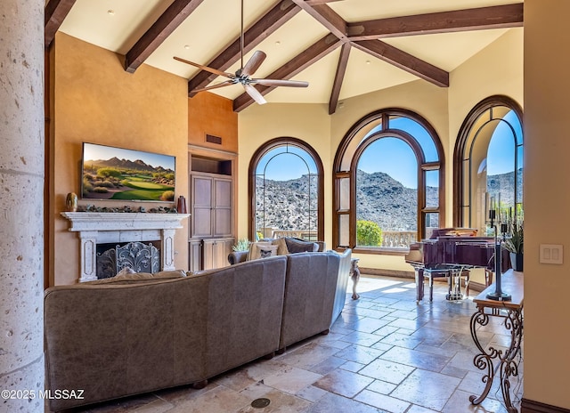 living room with beamed ceiling, visible vents, high vaulted ceiling, stone tile flooring, and a fireplace