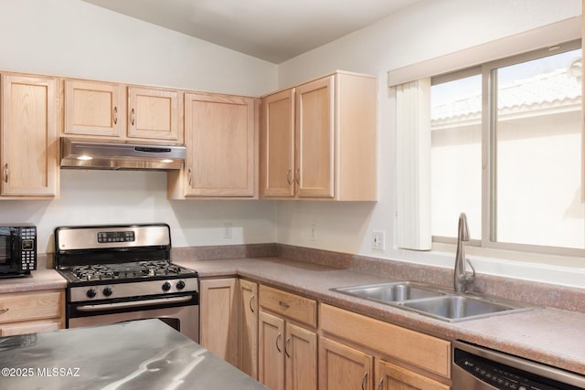 kitchen featuring light brown cabinets, under cabinet range hood, stainless steel appliances, a sink, and light countertops