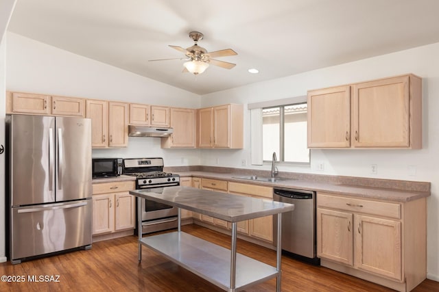 kitchen with stainless steel appliances, a ceiling fan, light brown cabinets, a sink, and under cabinet range hood