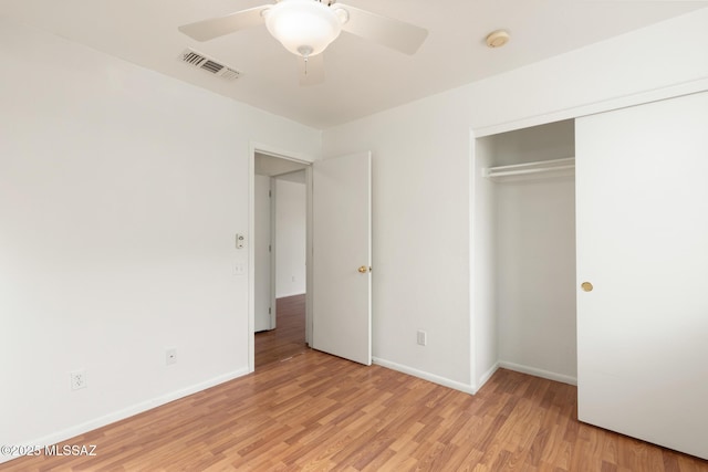 unfurnished bedroom featuring a closet, light wood-type flooring, visible vents, and baseboards