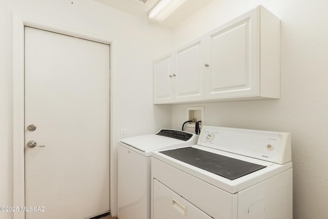 laundry room with cabinet space and washer and dryer